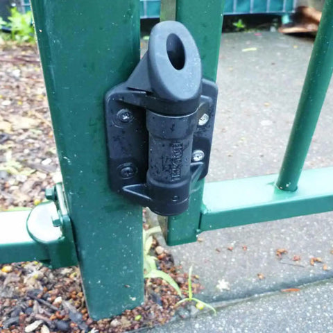 Close-up of 2 Pack Weatherproof Gate Hinges with Safe Spring Mechanism attached to green metal fence with no brainer install