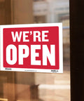 Open And Closed Sign 12x16 Inch Double Sided Vinyl Sign For Storefronts Offices Restaurants Bars Shops Waterproof Indoor Signage With Bold Lettering No Sweat For Window Doors Front Desk And Lobbies 1 Pack showing 'We're Open' on glass door