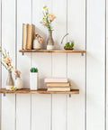 Decorative wooden shelves with books and vases, secured with Gray Furniture Anti Tip Anchors 12 Pack For Wall Attachment.