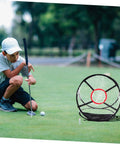 Child practicing golf putt with Indoor Golf Practice Net For Home And Office Use Portable Swing Training Target Net Durable Foldable Golf Net With Easy Setup And Stable Frame So You Can Hit Like A Pro At Home in background