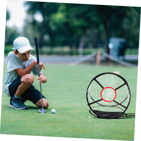 Child practicing golf putt with Indoor Golf Practice Net For Home And Office Use Portable Swing Training Target Net Durable Foldable Golf Net With Easy Setup And Stable Frame So You Can Hit Like A Pro At Home in background