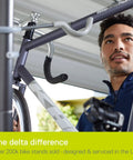 Man adjusting bicycle on Michelangelo Gravity Two Bike Storage Rack No Drill Wall Lean Vertical Bike Holder.