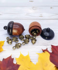 Hella Slick Screw Open Miniature Black Ebony Acorn Curios Set Of Two With Hidden Antique Bronze Pinecones, open revealing pinecones.