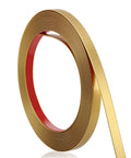 Kick Up Your Rooms With Matte Gold Peel And Stick Molding Trim, Super Slick DIY Decorative Edge Strip For Walls Ceilings Cabinets, Easy Mirror Baseboard Install That Is Gonna Look Fresh - Rolled matte gold molding trim on a red backing.