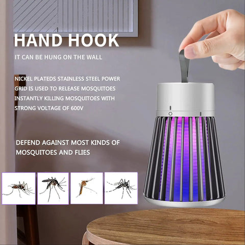 Hand holding Outdoor No Brainer Bug Zapper Portable Mosquito Killer For Camping And Home with 600V grid and purple LED.