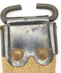 Close-up of steel fittings on WWII British Enfield Web Khaki Sling with steel fittings authentic dated military gear for SMLE rifles.