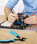 Person using electronics with precision flush wire cutters and stripping tools, slim diagonal cutters, 6 inch pliers nearby.