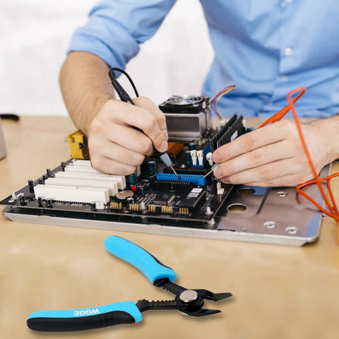 Person using electronics with precision flush wire cutters and stripping tools, slim diagonal cutters, 6 inch pliers nearby.