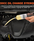 Hand-held H-veenjor 200 CC oil change syringe with 32-inch hose and two 9-inch tubes, evacuating engine oil.