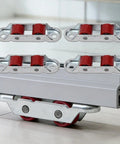 4Pcs Set Rock Solid Steel Slider Door Rollers With Silent Dual Nylon Wheels 16Mm Double Groove Design on a glass surface.