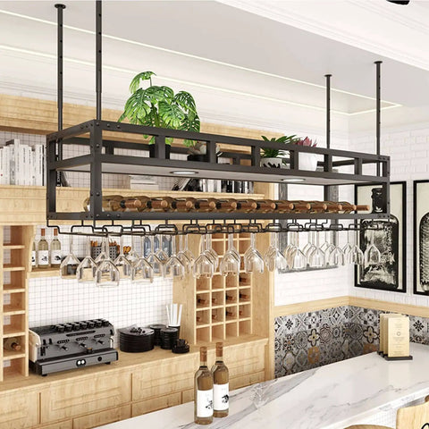 Ceiling Hanging Wine Glass Rack With Bottle Holder And Plant Shelf Overhead Bar Or Garage Storage Heavy Duty Iron Suspension 100 Kg Capacity Easy Mount Space Saving Display Stand installed in kitchen with glasses and plants.