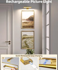 Rechargeable Picture Light For Wall With Remote Control Three Pack Sweet Stick On Magnetic Mount No Fuss Install Ultra Bright Frame Accent Lamp illuminating framed art in a hallway, showcasing charging process.