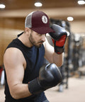 Man boxing indoors wearing Breathable Yacht Style Trucker Hat For Women And Unisex, Lightweight All Day Comfort With Anti Sweat Band