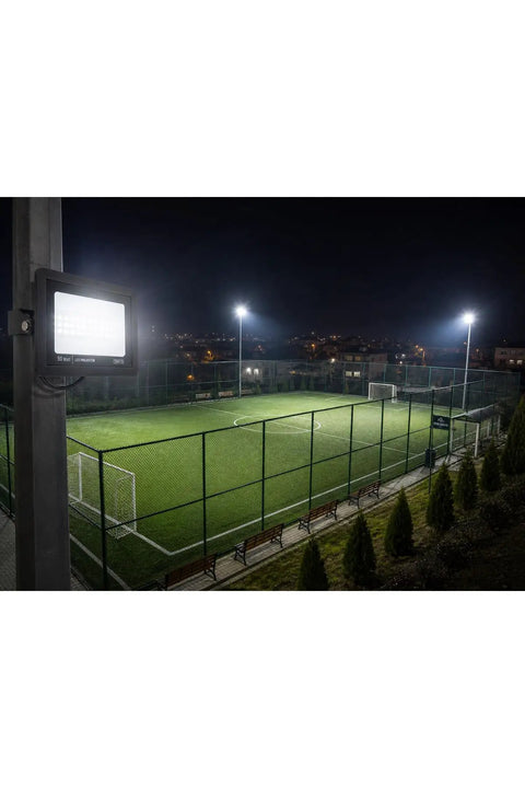 SODEF 50W LED Floodlight White Light IP65 Water-Resistant Outdoor High Lumen Energy Saving illuminating a night soccer field.
