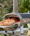 Gas Burner Attachment For Karu 12 2 12G Pizza Ovens in use with fresh pizza baking outdoors, showing installation on pizza oven.