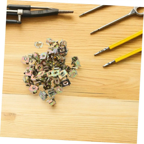 50 Pack Premium Automotive Fastener Clips Golden Iron Captive Nuts arranged on a wooden surface with tools.