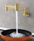 Brushed Gold Wall Mount Pot Filler Faucet With Folding Reach And Brass Construction Sixteen Point Seven Inch Extension