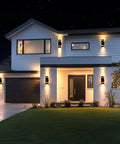 Modern house with Dusk To Dawn Outdoor Wall Light 2 Pack Brown Up Down Sconce illuminating porch and garage, IP65 rated