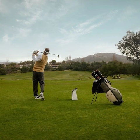 Golfer using Pro Grade Golf Launch Monitor And Simulator With 10 Inch Color Touchscreen Three Camera System More Than 15 Metrics GPS