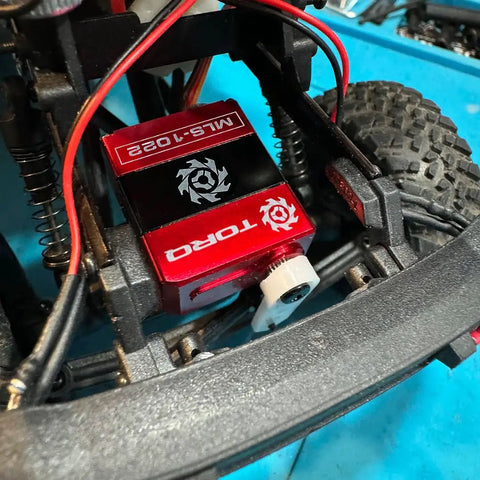 Beefy High Torque Micro Servo for 1 24 RC Crawlers, 5V to 8.4V Power, installed in Axial SCX24 with red and black casing