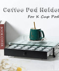 High Capacity Coffee Pod Drawer Organizer With Tempered Glass Top Holds 36 K Cup Pods in black metal frame on counter.