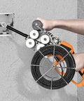 Cordless Brushless Electric Wire Puller 800W With 21V 4000mAh Battery, user demonstrating cable threading through a wall.