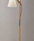 Walden Floor Lamp with natural wood body and satin steel base, adjustable height, off-white poly cotton bell shade, on display