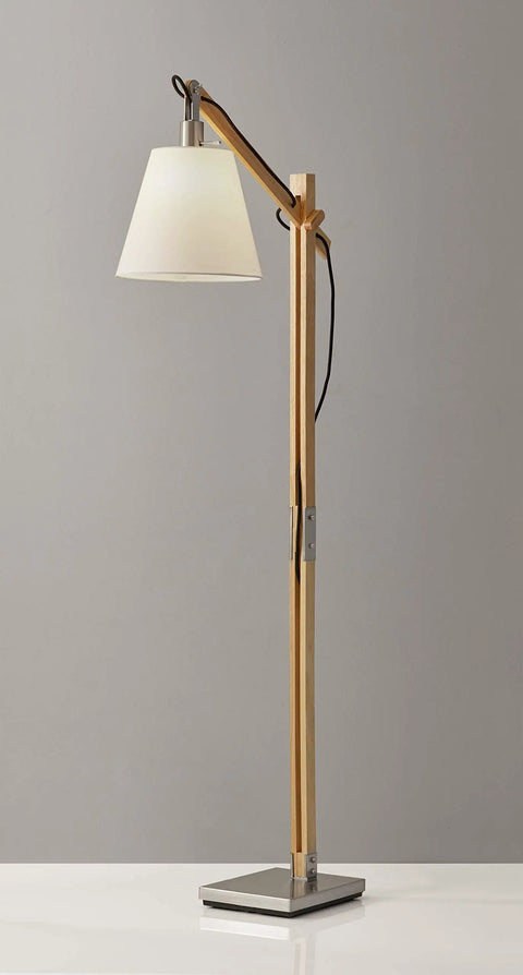 Walden Floor Lamp with natural wood body and satin steel base, adjustable height, off-white poly cotton bell shade, on display