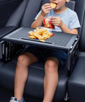 Child enjoying snacks on a Heavy Duty Foldable Car Tray For Tesla Cybertruck Steering Wheel Hook Snack Holder Laptop Stand.