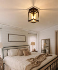 Semi Flush Mount Ceiling Light With Bronze Metal Frame And Clear Glass Shade, Farmhouse Style Fixture in bedroom setting.