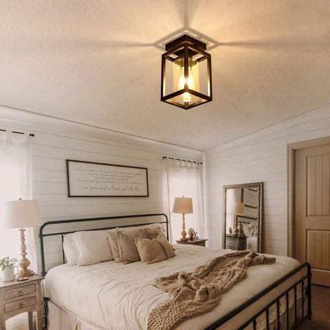 Semi Flush Mount Ceiling Light With Bronze Metal Frame And Clear Glass Shade, Farmhouse Style Fixture in bedroom setting.