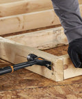 Person using IsoCore 22 Oz Milled-Face Framing Claw Hammer With Shock Reduction Dual-Layer Grip on wooden framing