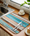 Go To Absorbent Dish Drying Mat 16 By 18 Inches in vintage wood grain with blue brown white finish on kitchen counter with cutlery
