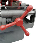 Electric Pipe Threader Workhorse One Half To Two Inch NPT With Twenty Eight RPM Threading Cutter Three In One Tool For Threading Cutting And Reaming Includes Clamping Device And Oiling System Built For Construction And Installation Jobs close-up of red handwheel and pipe clamp