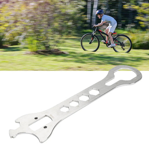 Stainless Steel Bottom Bracket Wrench For Bikes Multifunctional BB Removal And Installation Tool in front of blurred cyclist background