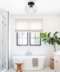 Industrial Semi Flush Mount Ceiling Light With Seeded Glass Shade installed in a bright bathroom setting