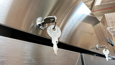 Key inserted into lock of Top Shelf Commercial 3 Door Reach In Refrigerator, Built Tough Stainless Steel Display Cooler.