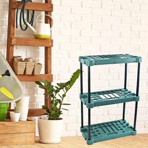 Heavy Badass Broom And Mop Organizer Rock Solid Corner Rack With Hella Durable Polypropylene Shelves And Reinforced Iron Frame Top Shelf Laundry Room Garage Cleaning Tools Storage Rack displayed with gardening tools and plant.