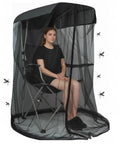 Person seated in a canopy chair covered by mosquito net for canopy chair and patio swing with zipper door extra large no-see-um breathable mesh bug tent cover