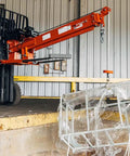Heavy Duty Fork Mounted Jib Crane With Electric Winch Pivoting Telescopic Boom Extends To 138 Inches Wireless Remote handles a load.
