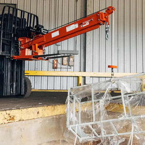 Heavy Duty Fork Mounted Jib Crane With Electric Winch Pivoting Telescopic Boom Extends To 138 Inches Wireless Remote handles a load.