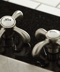 Hot and Cold handles of French Country Widespread Lavatory Faucet With Pop Up Drain in Brushed Nickel, elegant classic style.