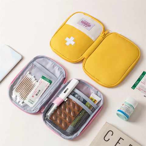 Open Must Have Emergency First Aid Bag Grab And Go Medical Kit with customizable compartments, yellow nylon pouch on desk.