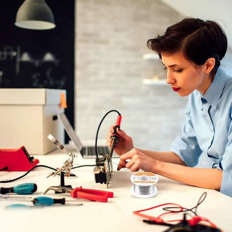 Person soldering electronics with 60-40 Tin Lead Rosin Core Solder Wire For Electrical Soldering And DIY Projects 0.6mm Diameter 0.11lbs Spool