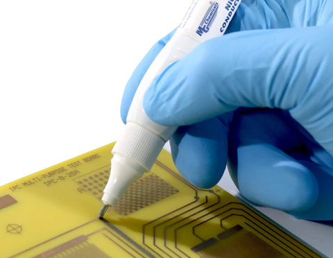 Applying Total Ground Carbon Conductive Pen 4g on PCB, showcasing electronics prototyping with quick-dry adhesive, 0.46 ohm-cm