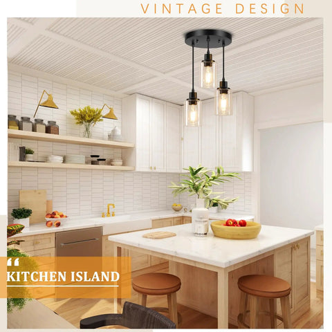 Slick Three Light Black Pendant Fixture With Crystal Clear Glass Shades and Fully Adjustable Suspension Cords above kitchen island.