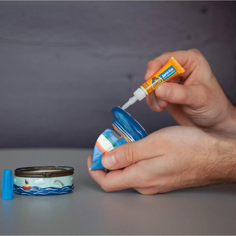 Applying Clear All Purpose Glue In Four 3 Gram Tubes With Fast Setting For Projects And Repairs Bonds Glass Plastic Wood Metal Ceramic Rubber Leather Paper And More Featuring Crystal Clear Formula And High Impact Tough Bond For Quick Seamless Fixes to a ceramic object