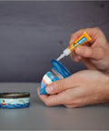 Person using Clear Fast Setting Super Glue Two 3 Gram Tubes Adhesive Pack Of 1 With Anti Clog Cap And Impact Tough Formula Bonds Plastic