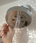 Neo Anystream High Pressure Adjustable Shower Head 2.5 GPM Polished Chrome with Custom Spray Patterns being adjusted by hand
