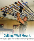 Man installing 2 Pack 5 Slot Fishing Rod Holder Rack Wall Or Ceiling Mount Heavy Duty Organizer in garage for storage